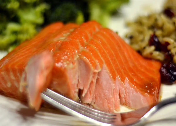 wild pink smoked salmon retort on a plate with fork