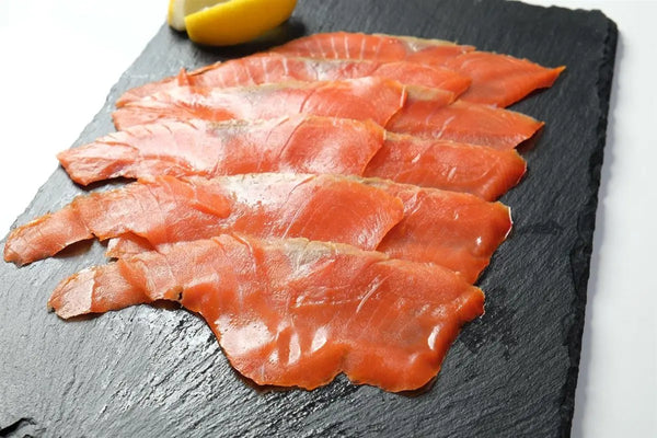 Wild Sockeye Smoked Salmon Slices on a slate board